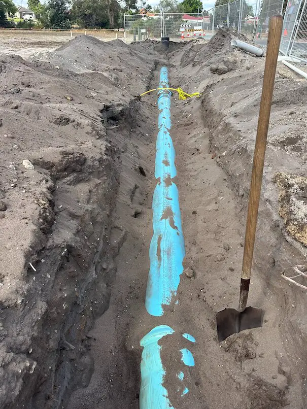 Careful excavation around live services for Henley Brook water main